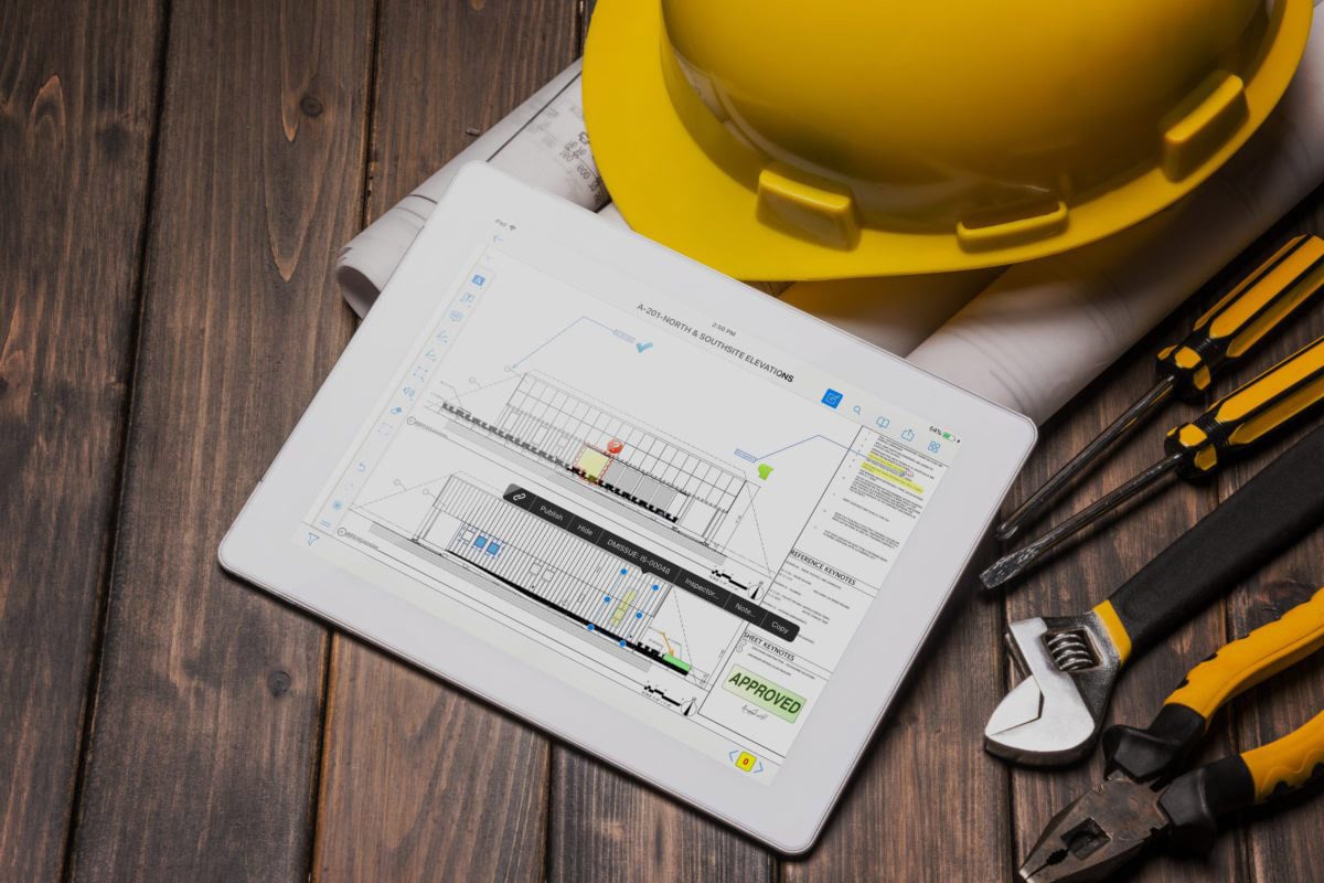 An iPad showing construction blueprints with annotations.